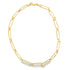 A shiny gold paperclip chain necklace rests on a plain white background.