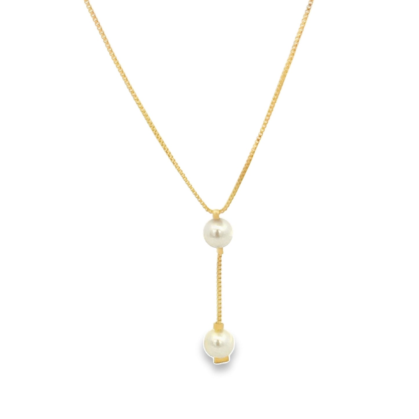 A delicate gold lariat necklace features two dangling pearls against a clean white background.