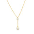 A delicate gold lariat necklace features two dangling pearls against a clean white background.