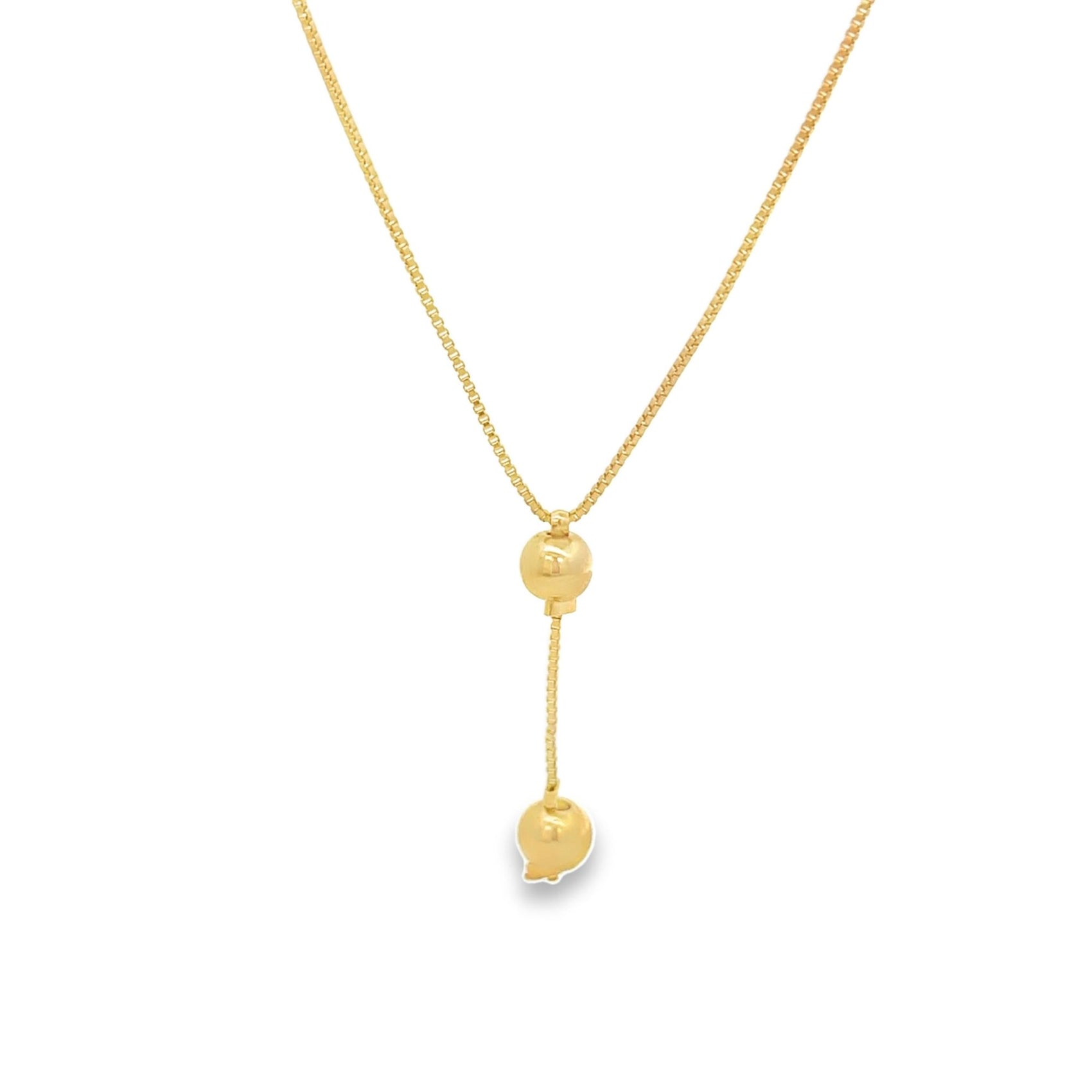 A delicate gold lariat necklace features a sliding bead and a hanging pendant against a white background.