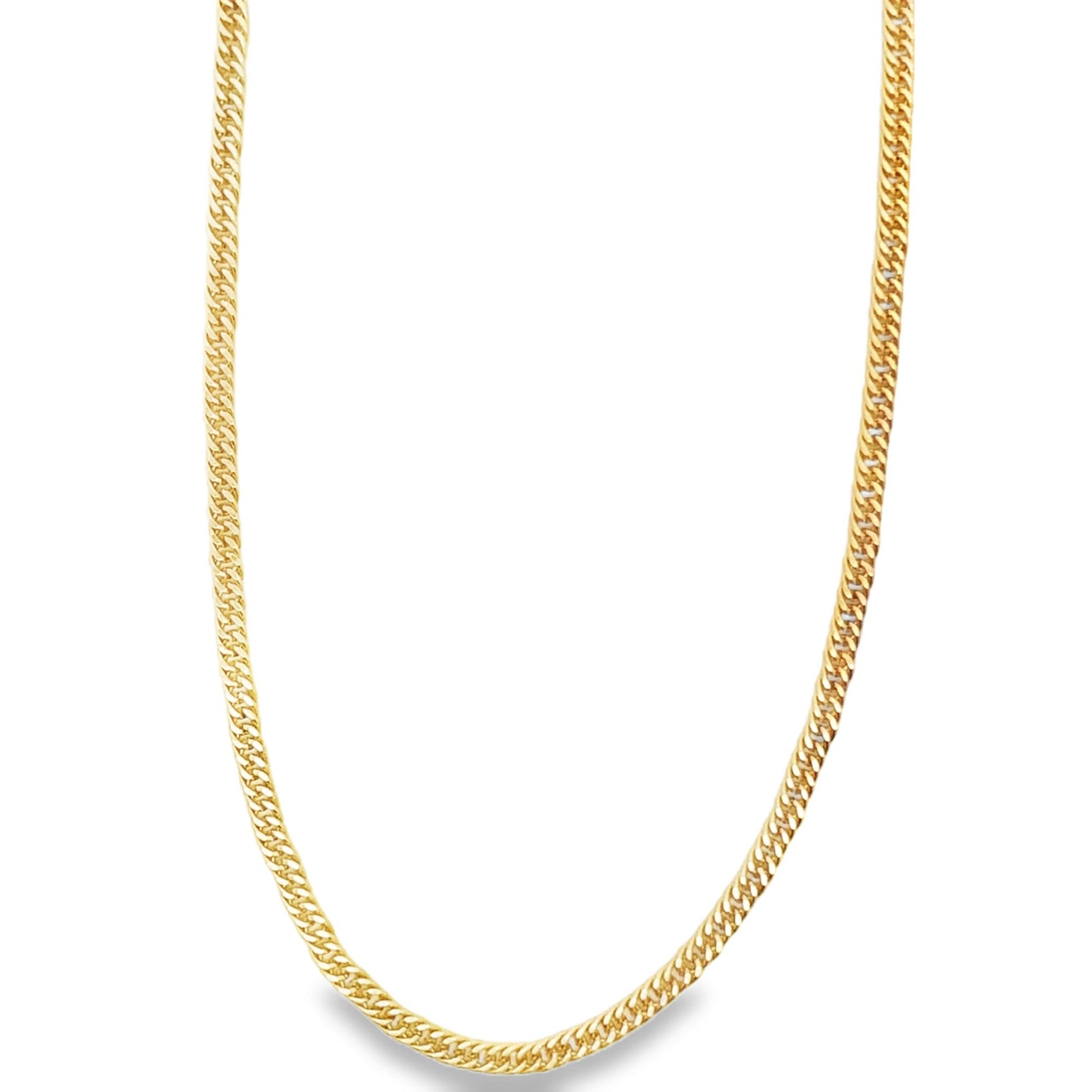 A classic gold cuban link chain necklace drapes against a clean white background.