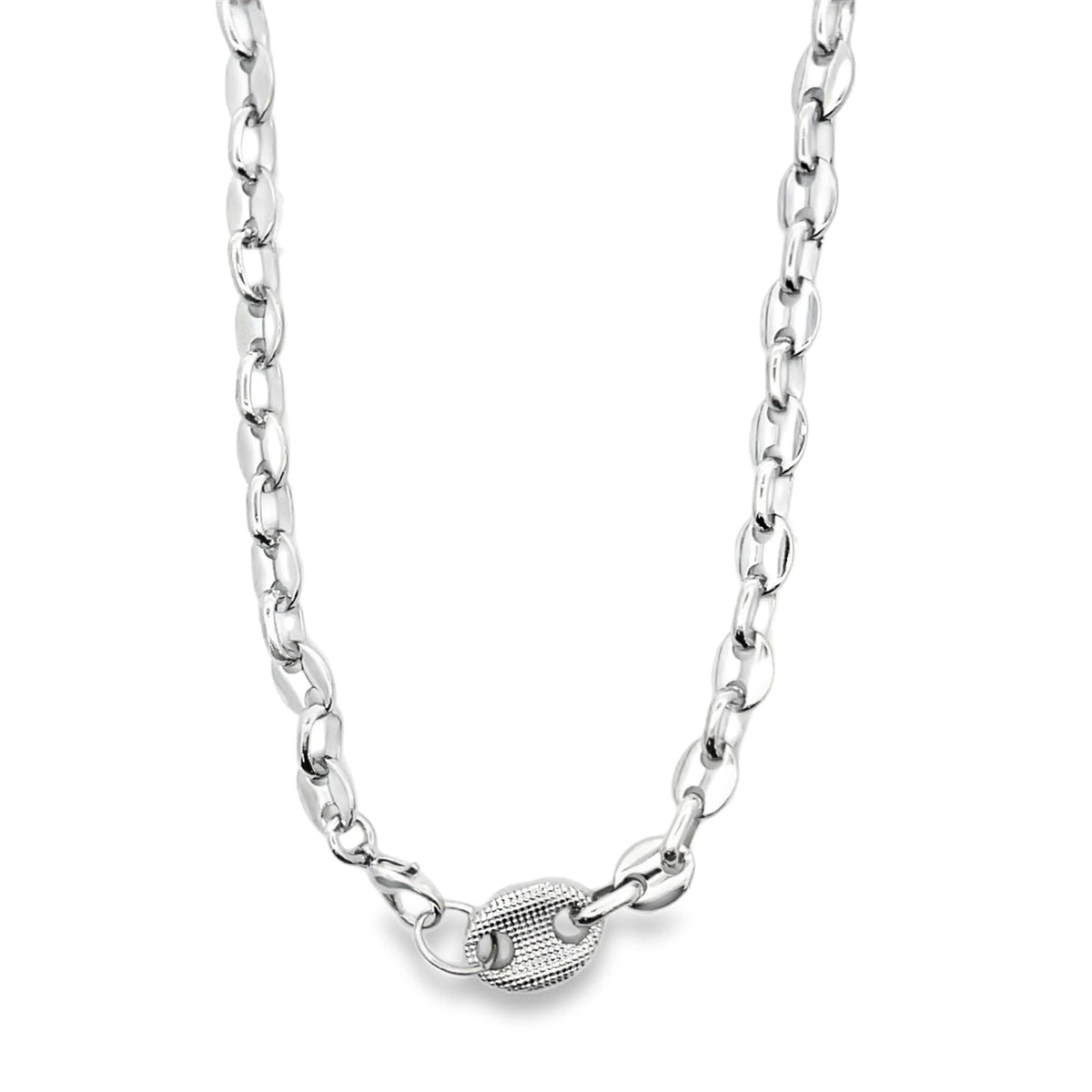 A polished silver mariner link chain necklace displays a textured, oval pendant at its clasp.