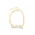 A gold chain bracelet features a sparkly rhinestone-encrusted "LOVE" charm against a plain white background.