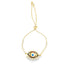 A delicate gold adjustable bolo bracelet features a vibrant evil eye charm encrusted with colorful stones and sparkling cubic zirconia along the chain.