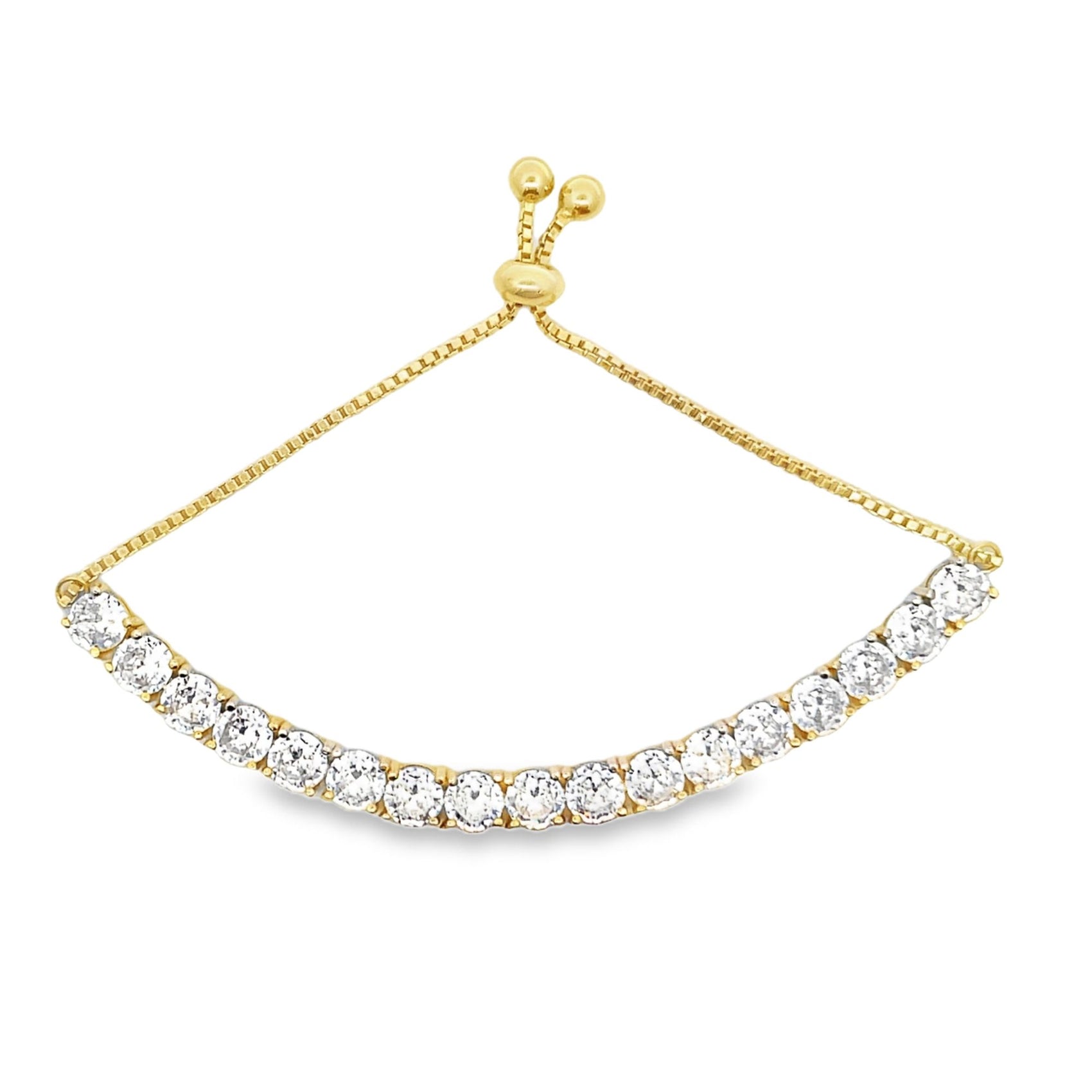 A delicate gold bolo tennis bracelet features a curved line of sparkling cubic zirconia stones and an adjustable sliding clasp.