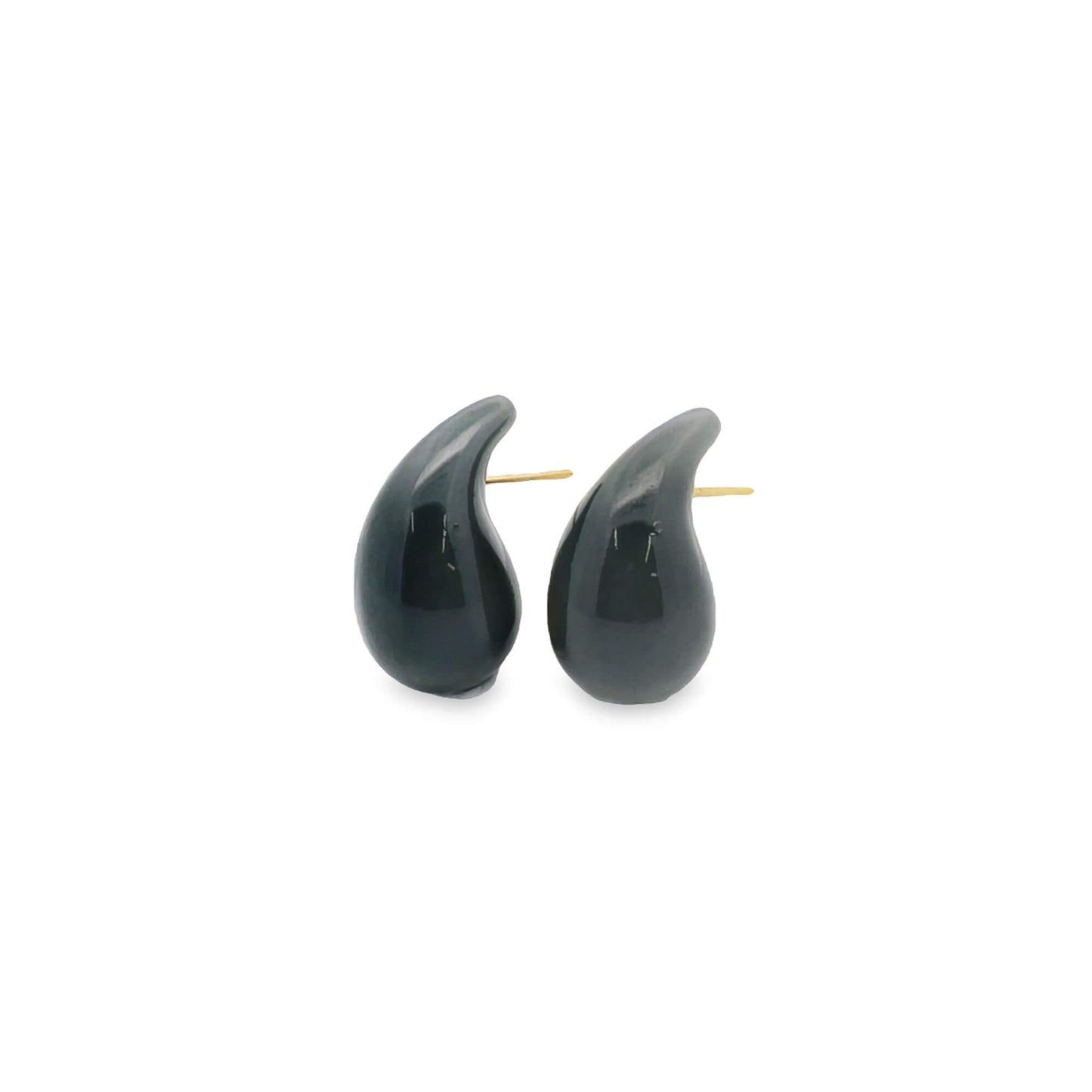 A pair of glossy black teardrop-shaped stud earrings rests against a clean white background.