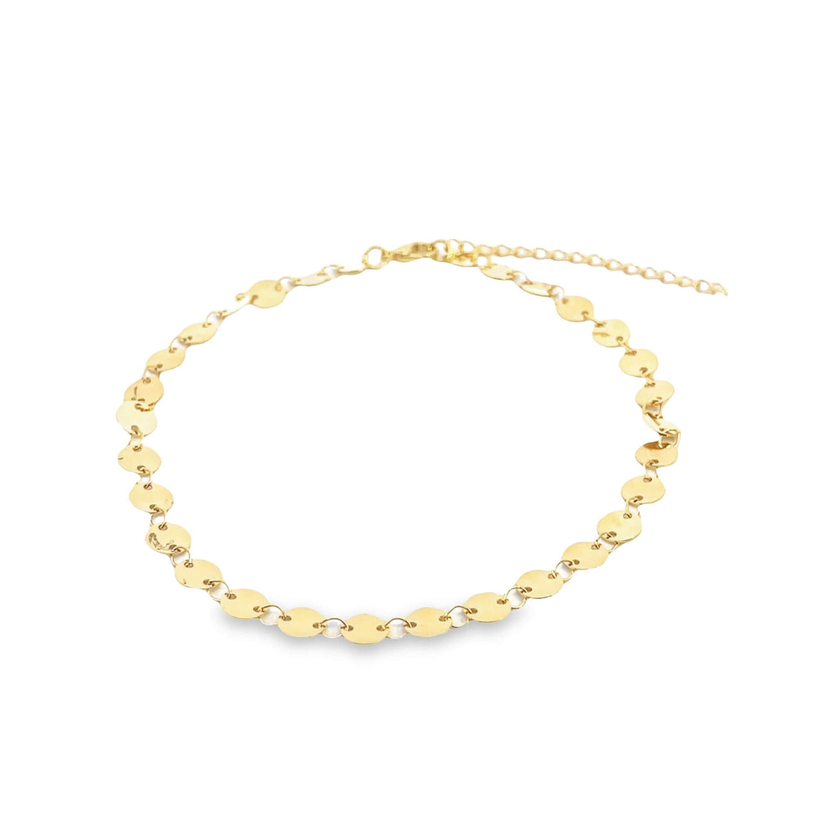 A delicate gold choker necklace features a continuous line of flat, shimmering coin discs against a clean white background.