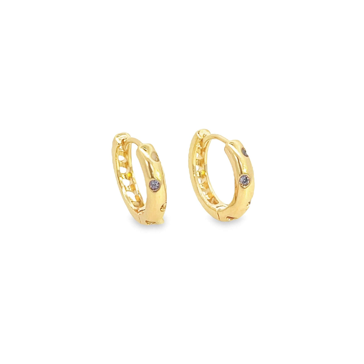 A pair of small gold huggie hoop earrings features embedded purple gemstone accents against a clean white background.
