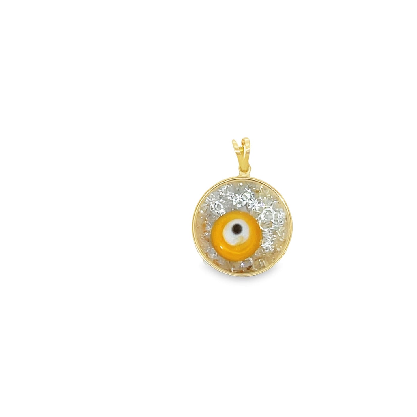 A gold evil eye pendant features a central yellow and white design set against a shimmering silver background.
