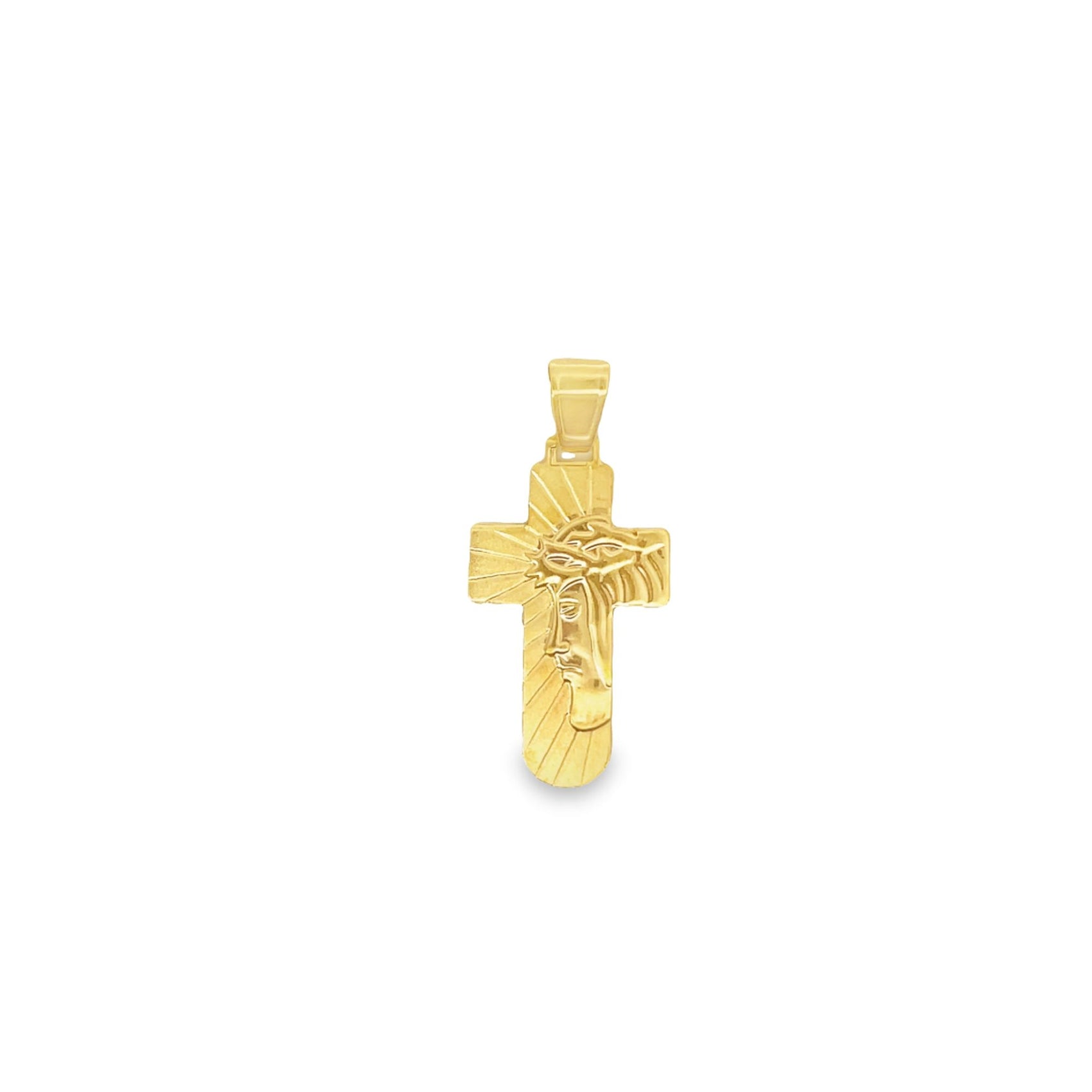 A polished gold cross pendant features an embossed profile of Jesus Christ with a sunburst background.