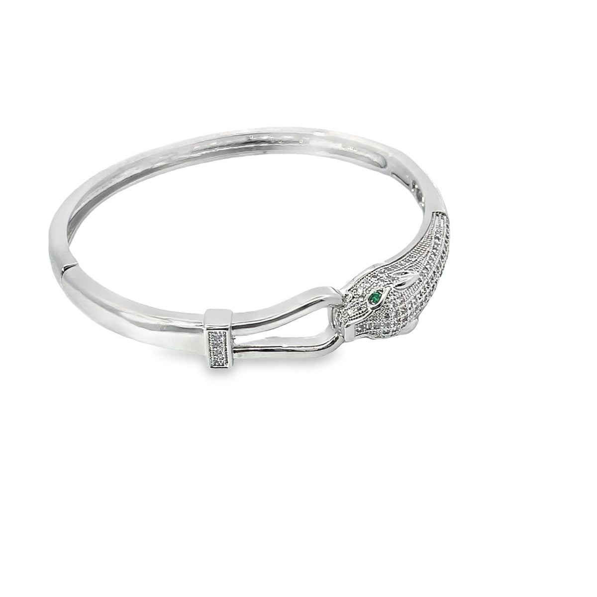 A silver panther bangle bracelet features sparkling pave-set cubic zirconia crystals and striking green emerald eyes.
