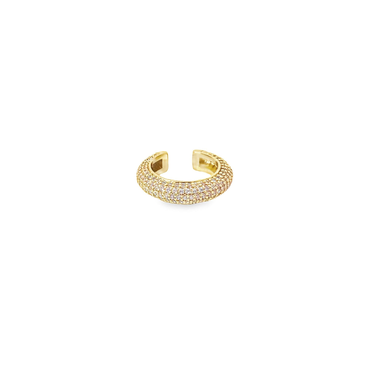A gold ear cuff sparkles with pavé-set stones against a clean white background.