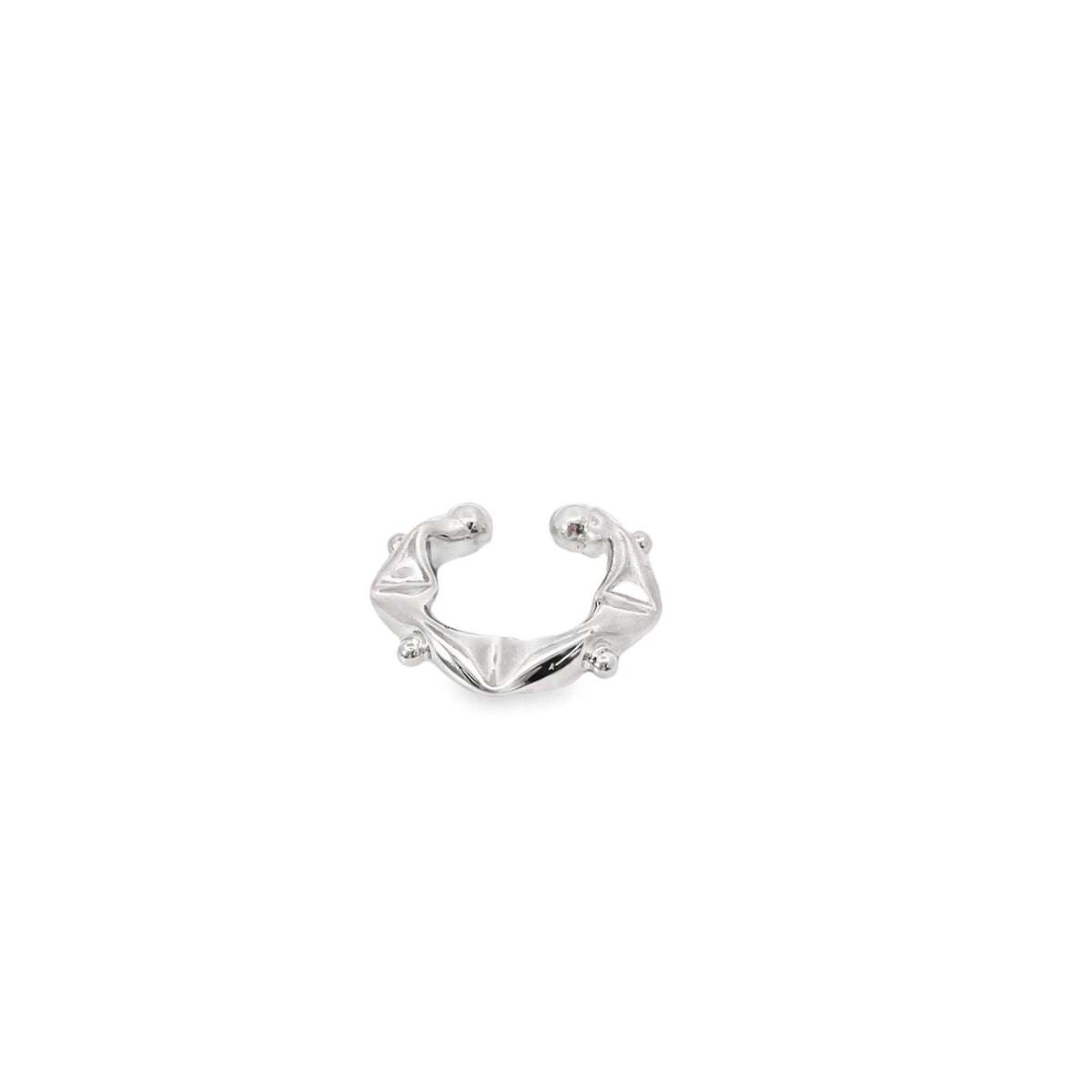 A modern silver ear cuff features an abstract, melted design with small ball accents on a plain white background.