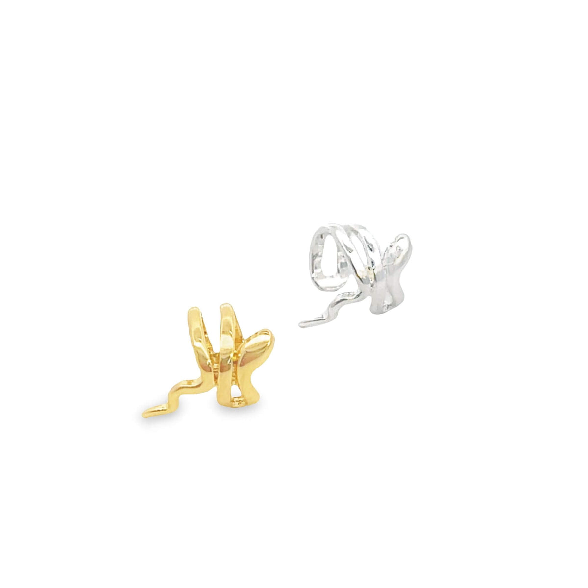 A pair of gold and silver snake ear cuffs rest against a clean white background.