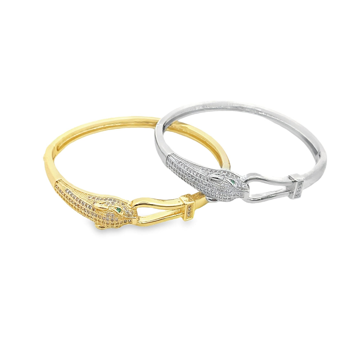 Two interlocking gold and silver animal-head bangles studded with pavé diamonds rest against a white background.