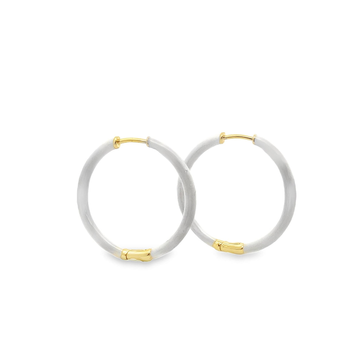 A pair of elegant hoop earrings features matte white enamel coating accented by polished gold metal details.