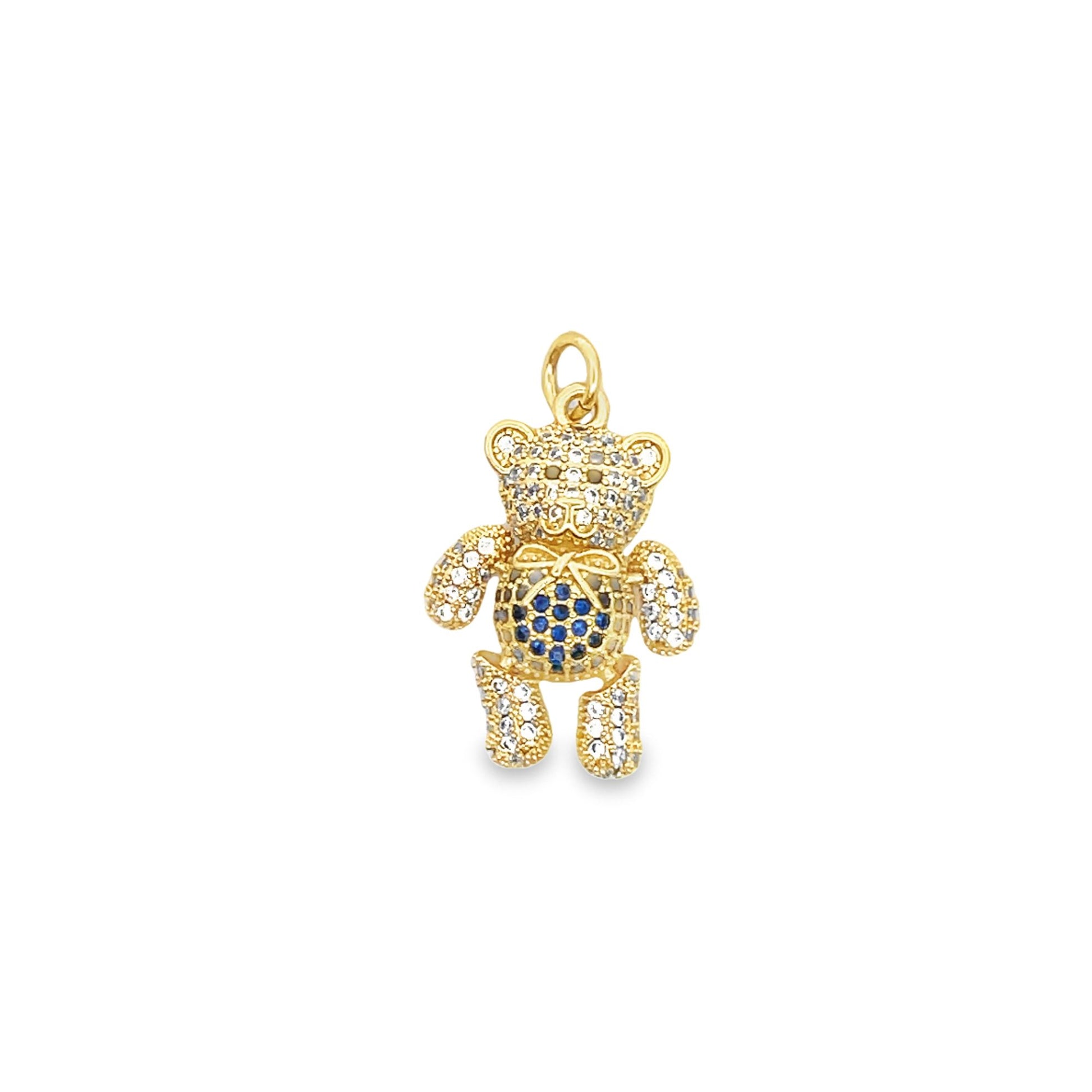 A gold teddy bear pendant sparkles with pavé white and blue crystals against a plain white background.