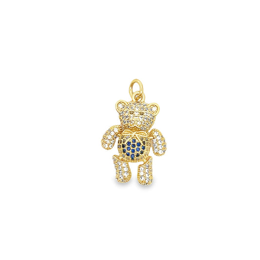A gold teddy bear pendant sparkles with pavé white and blue crystals against a plain white background.