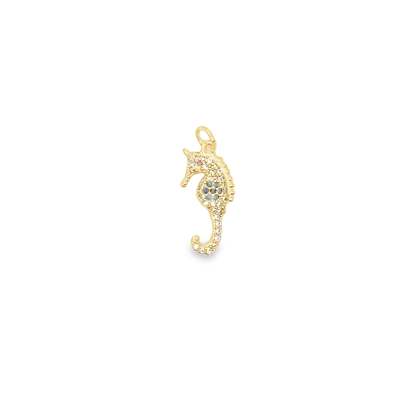 A delicate gold seahorse pendant features sparkling pave crystals and colorful accents on a white background.
