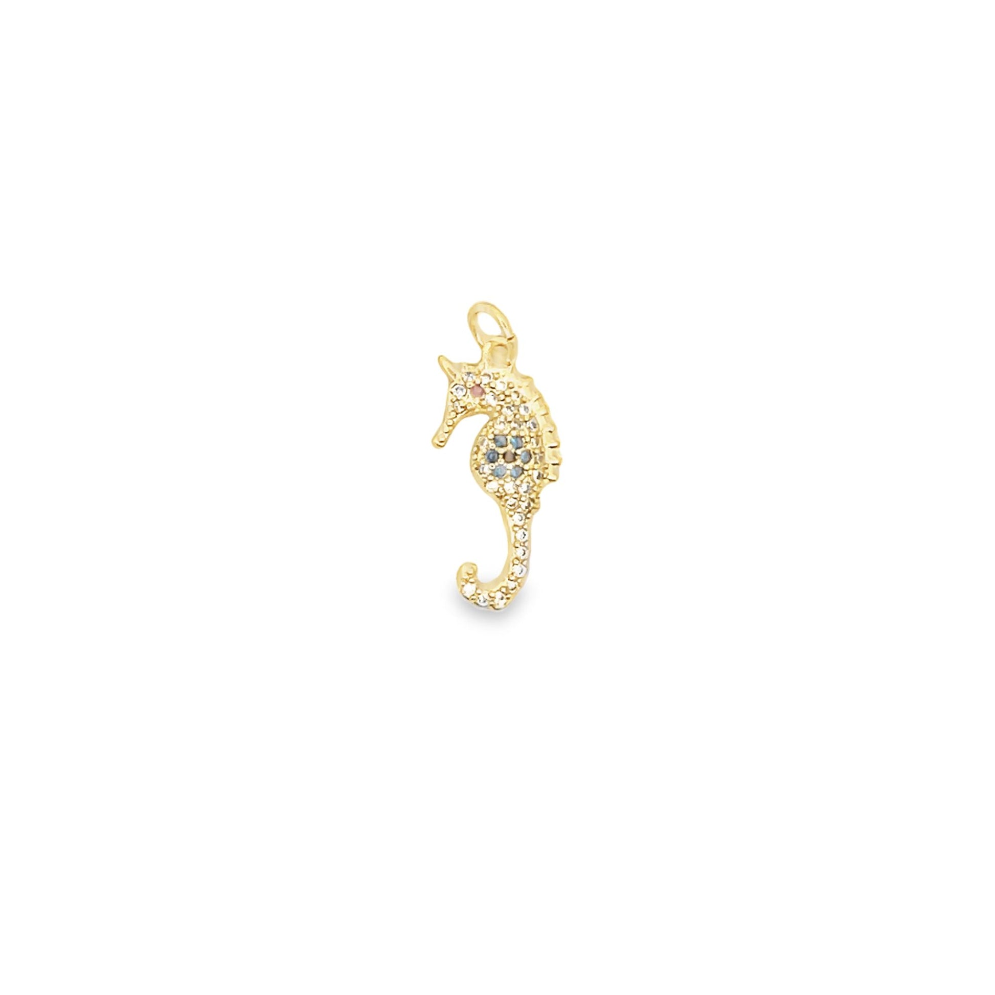 A delicate gold seahorse pendant features sparkling pave crystals and colorful accents on a white background.