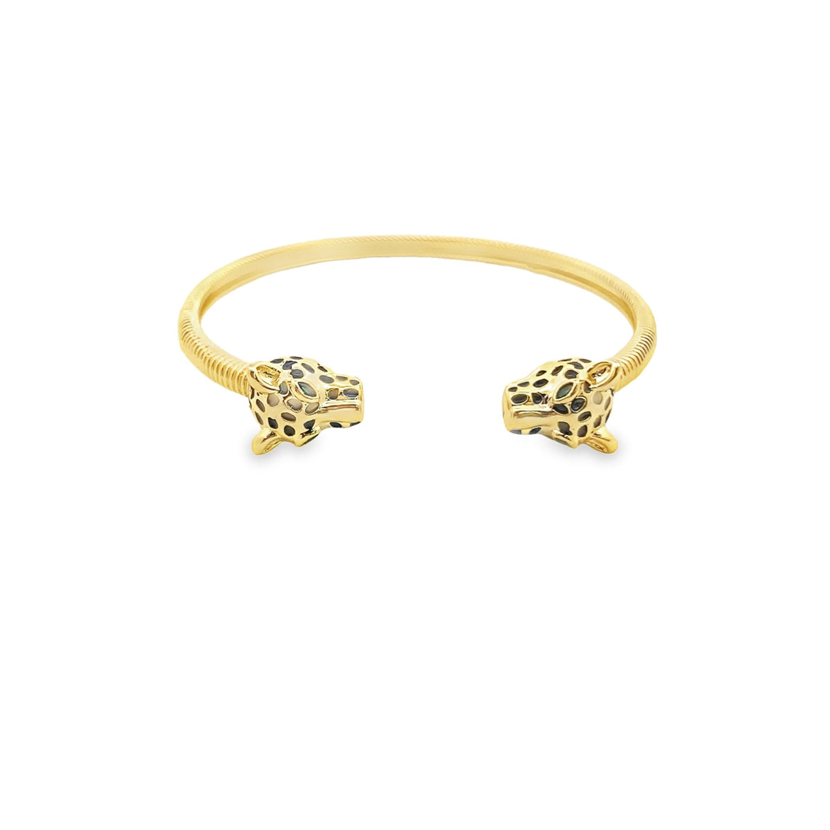 A gold cuff bracelet features sculpted leopard heads with black enamel spots at each open end.
