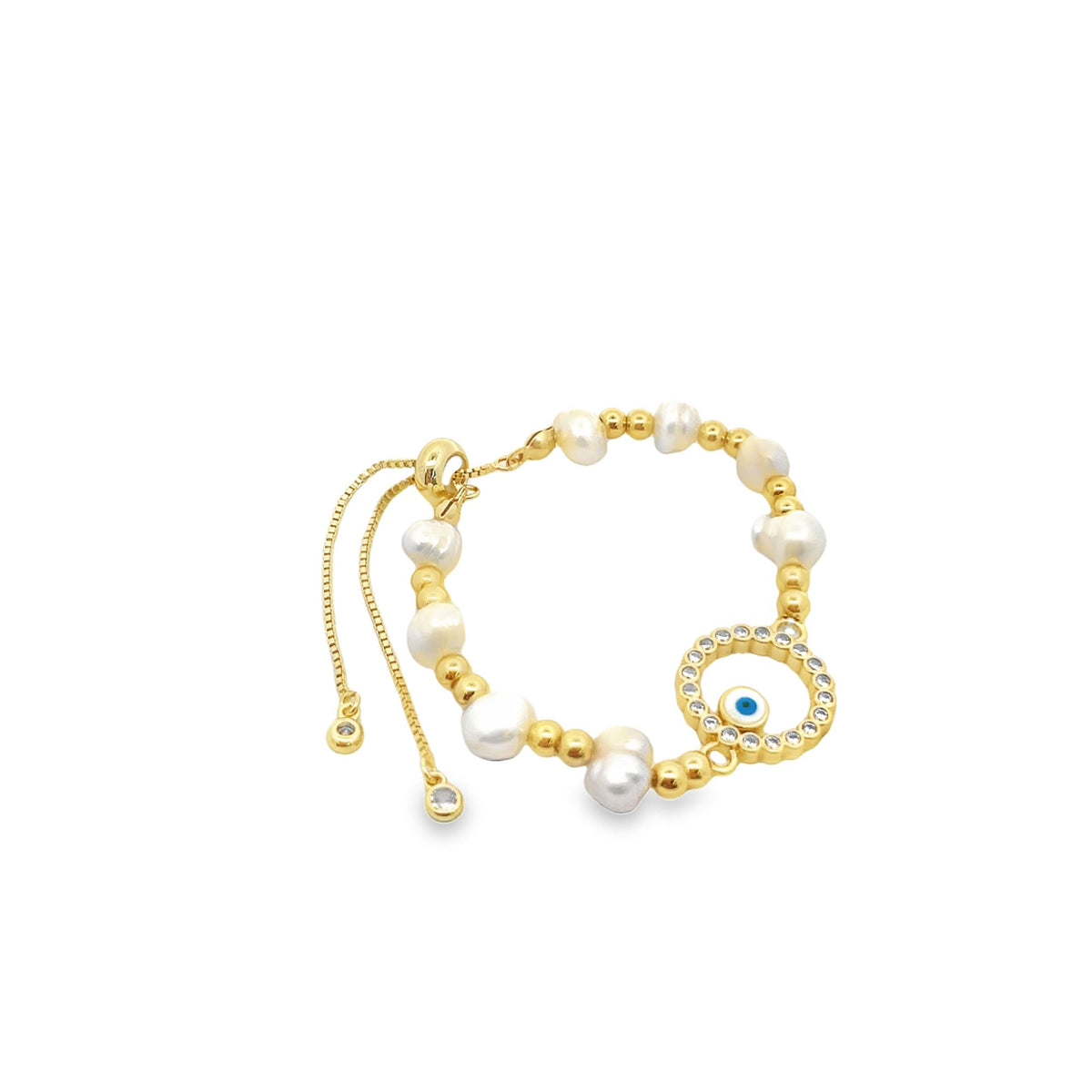 A gold adjustable bracelet features white freshwater pearls and a sparkling evil eye charm against a white background.