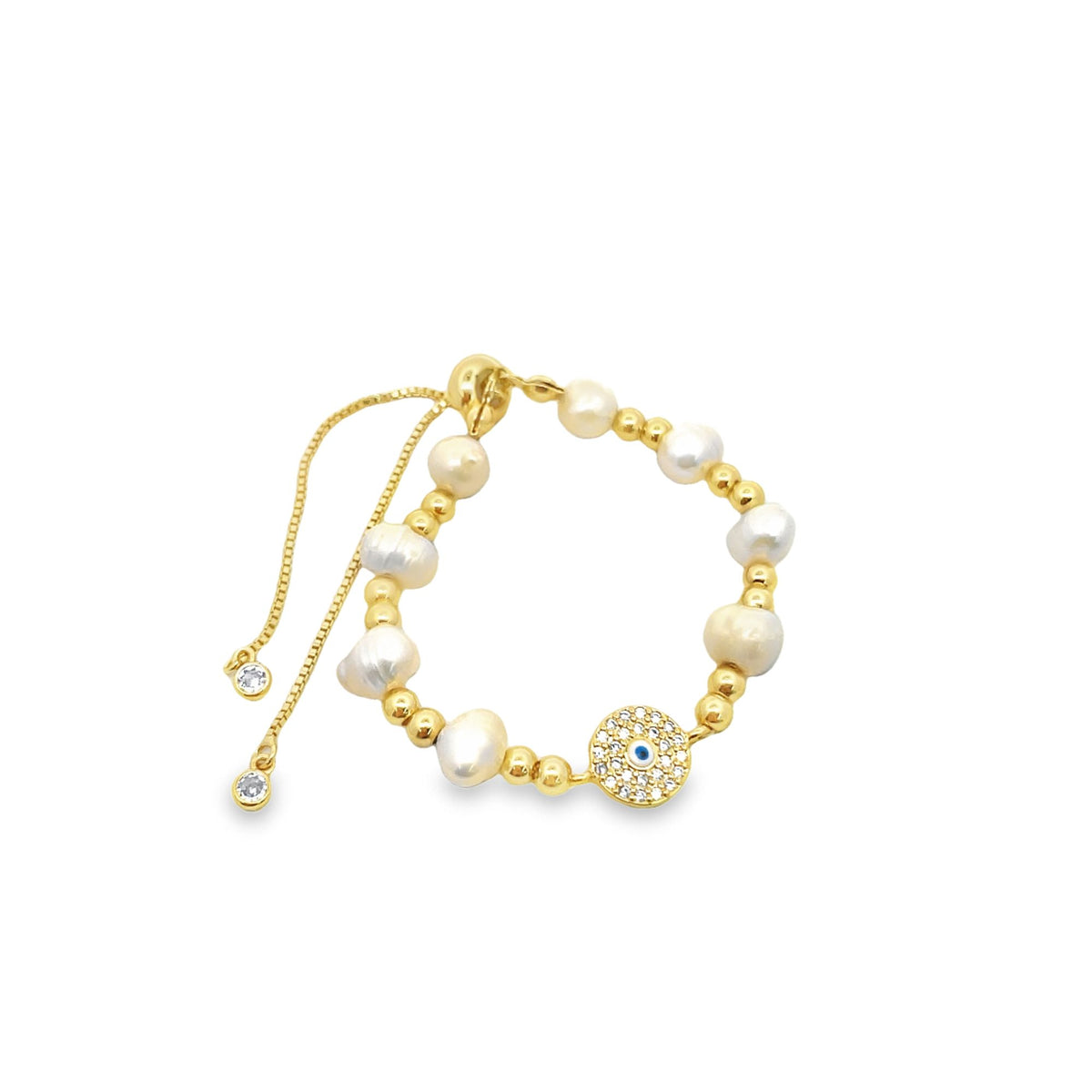 A gold slider bracelet features alternating freshwater pearls and gold beads alongside a sparkling evil eye charm.