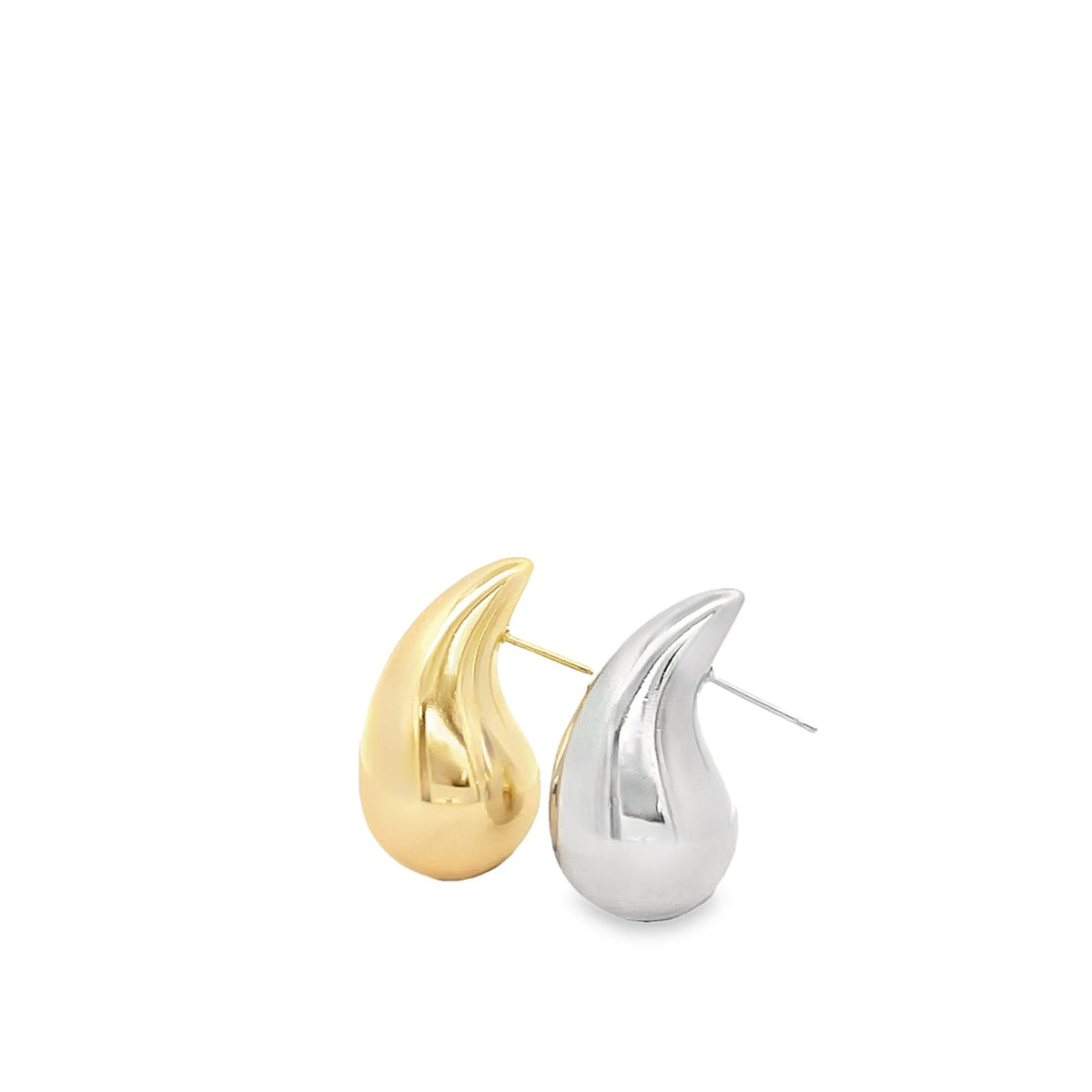 A pair of minimalist teardrop earrings in polished gold and silver showcases smooth, sculptural curves against a clean white background.