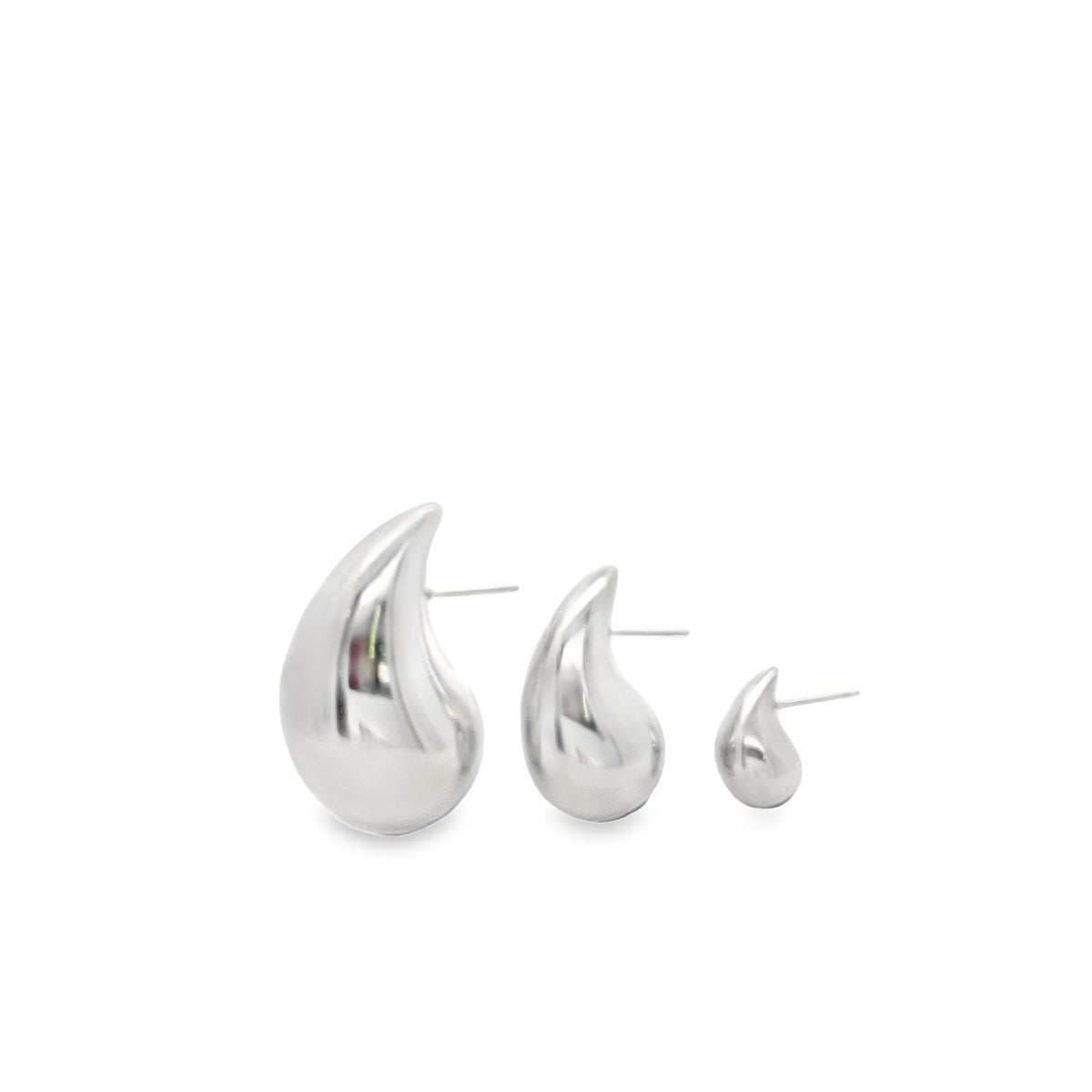 Three polished silver teardrop earrings in descending sizes rest in a row on a white background.