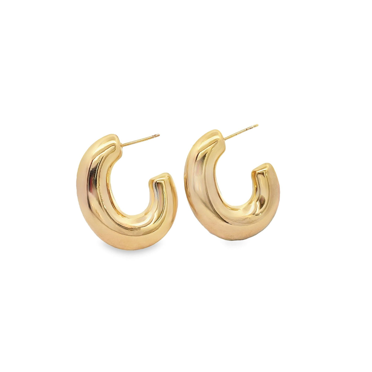 A pair of chunky gold hoop earrings rests against a clean white background.