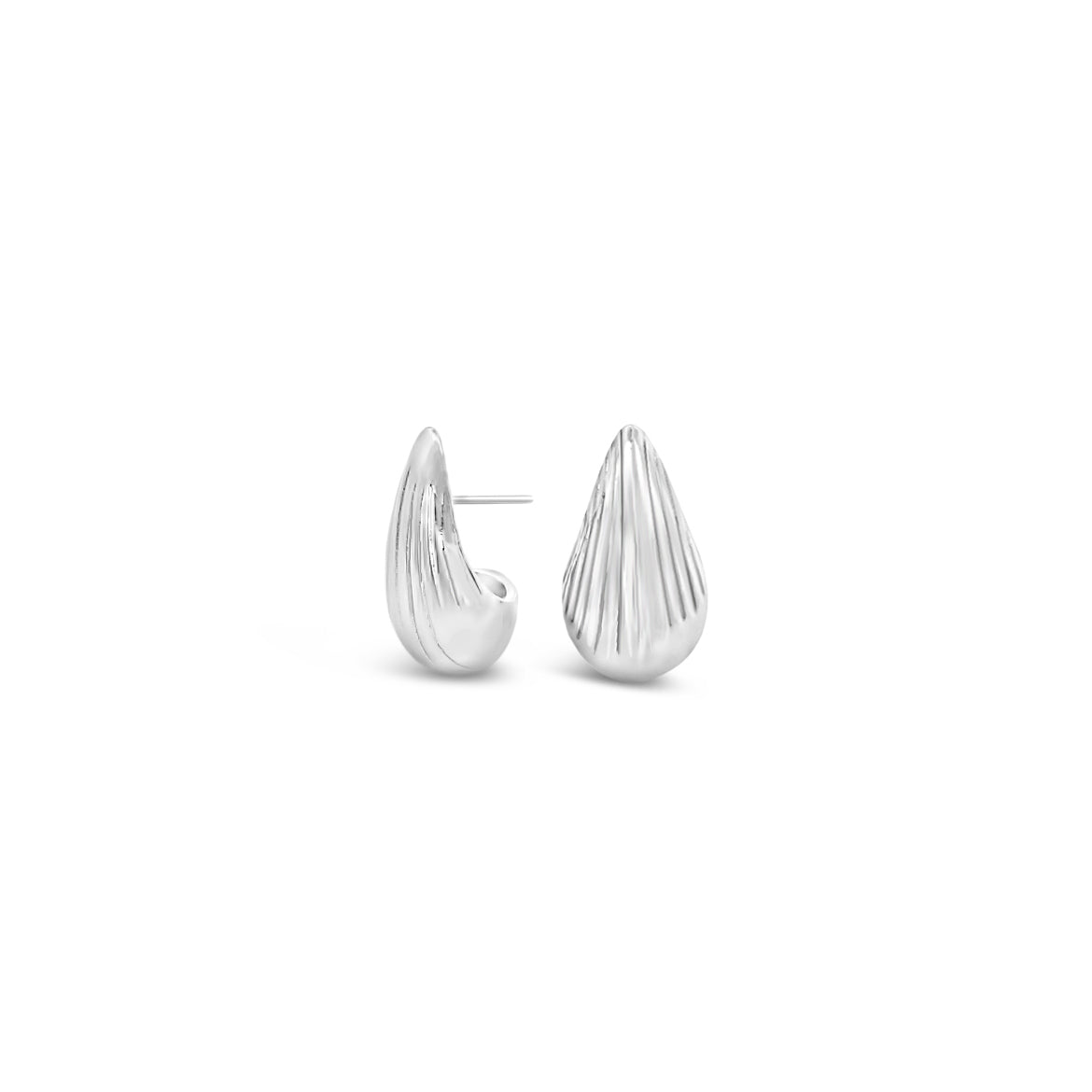 A pair of ribbed silver teardrop earrings rests against a white background.