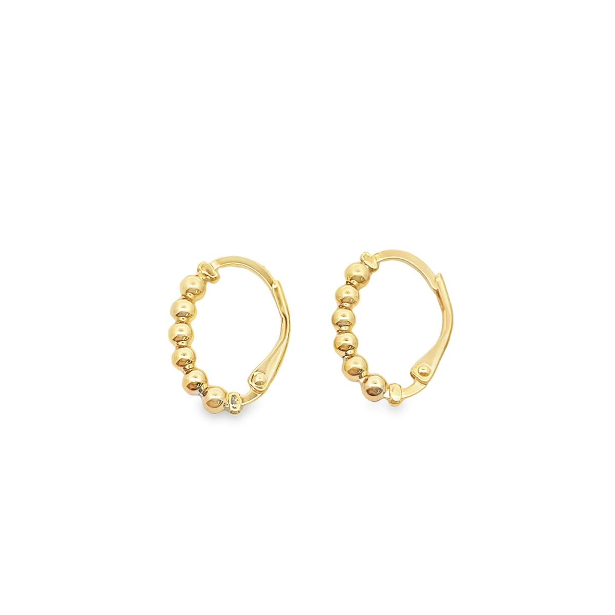 A pair of gold huggie hoop earrings featuring a beaded design sit against a clean white background.