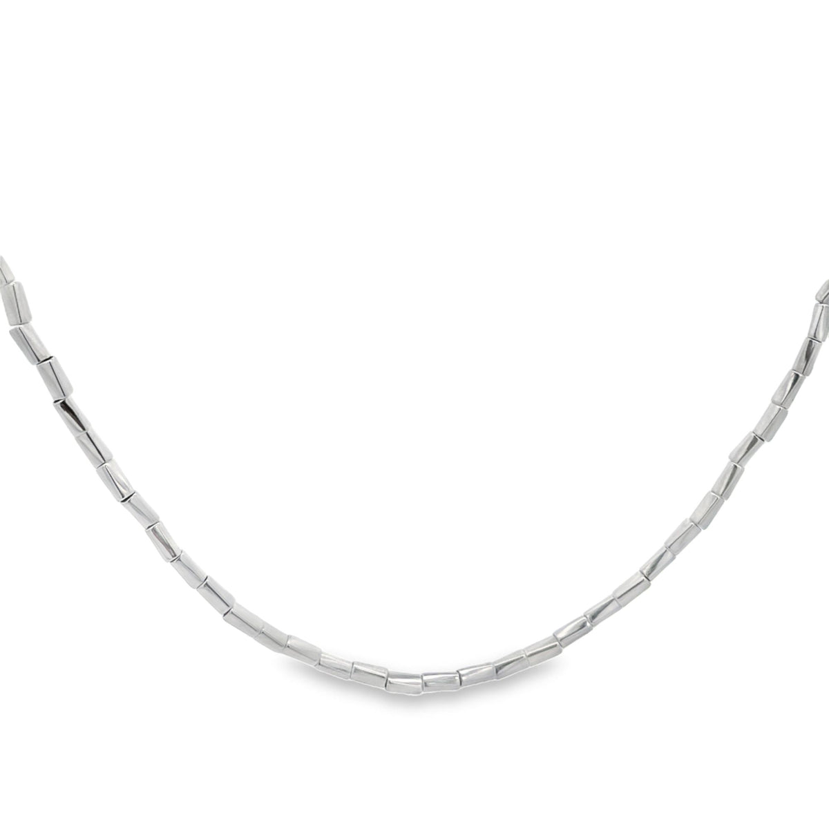 A polished sterling silver beaded necklace curves gracefully against a clean white background.