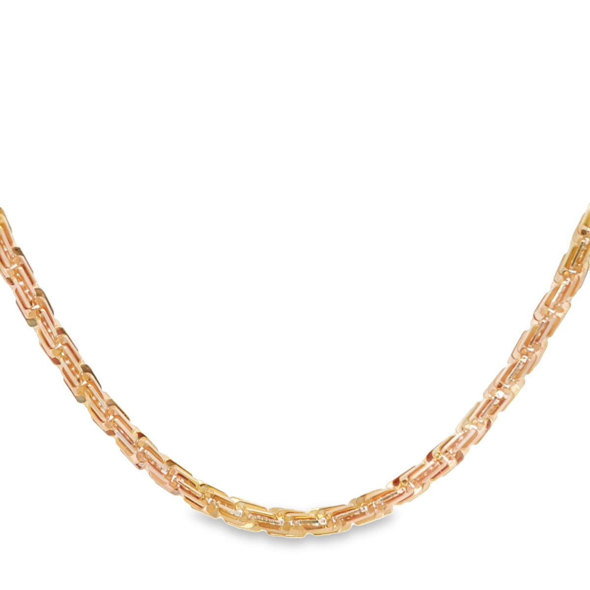 A sleek Byzantine chain necklace made of 14k tri-color gold curves gracefully against a clean white background.