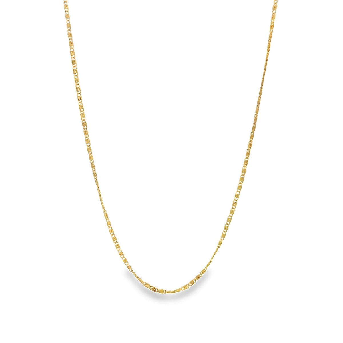 A delicate gold chain necklace hangs against a clean white background.