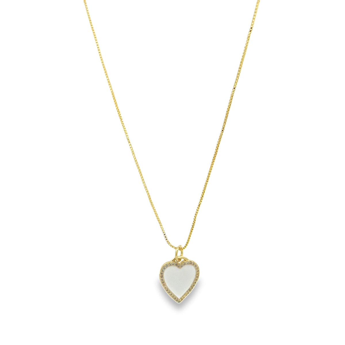 A delicate gold chain necklace displays a sparkling heart-shaped pendant with a white enamel inlay.