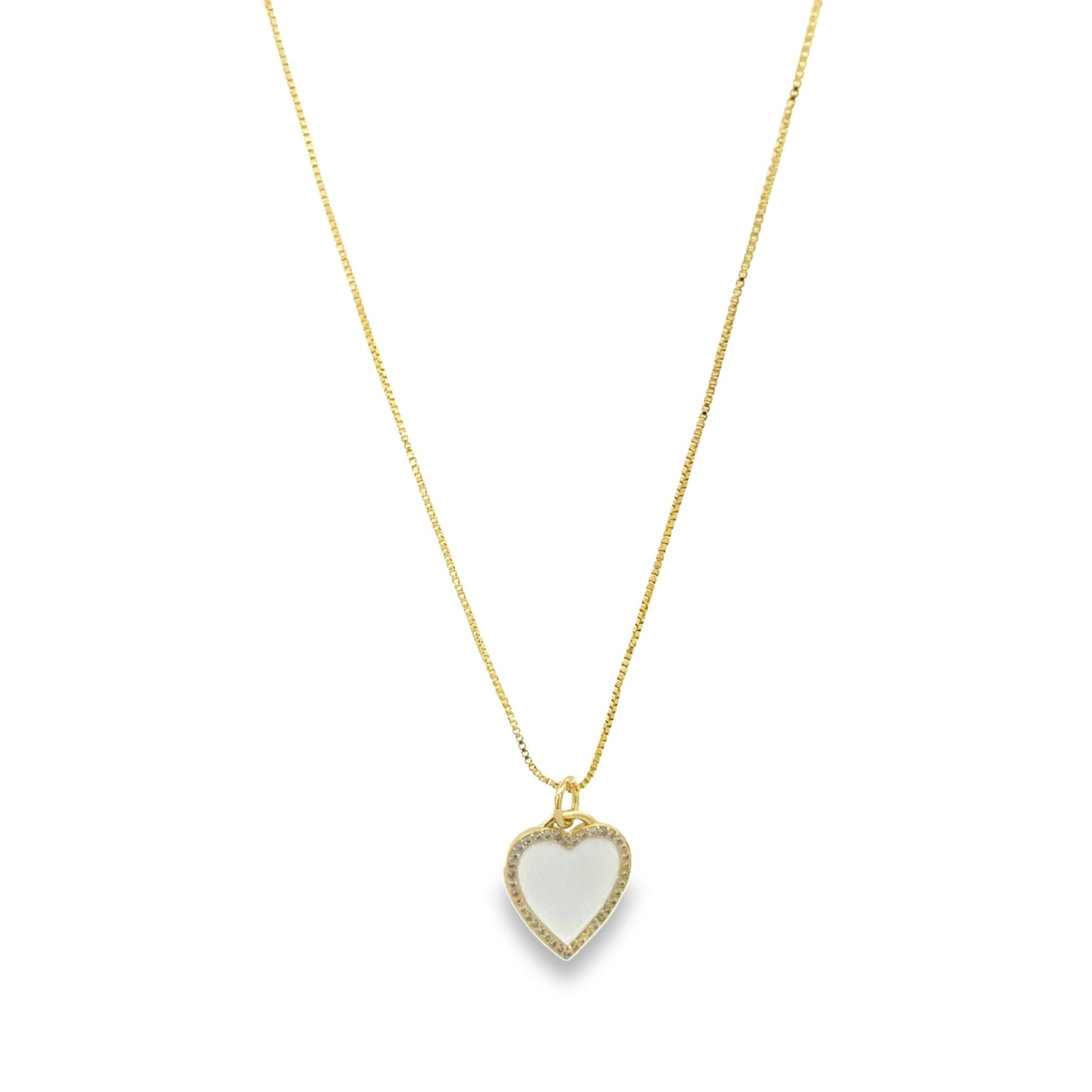 A delicate gold chain necklace displays a sparkling heart-shaped pendant with a white enamel inlay.