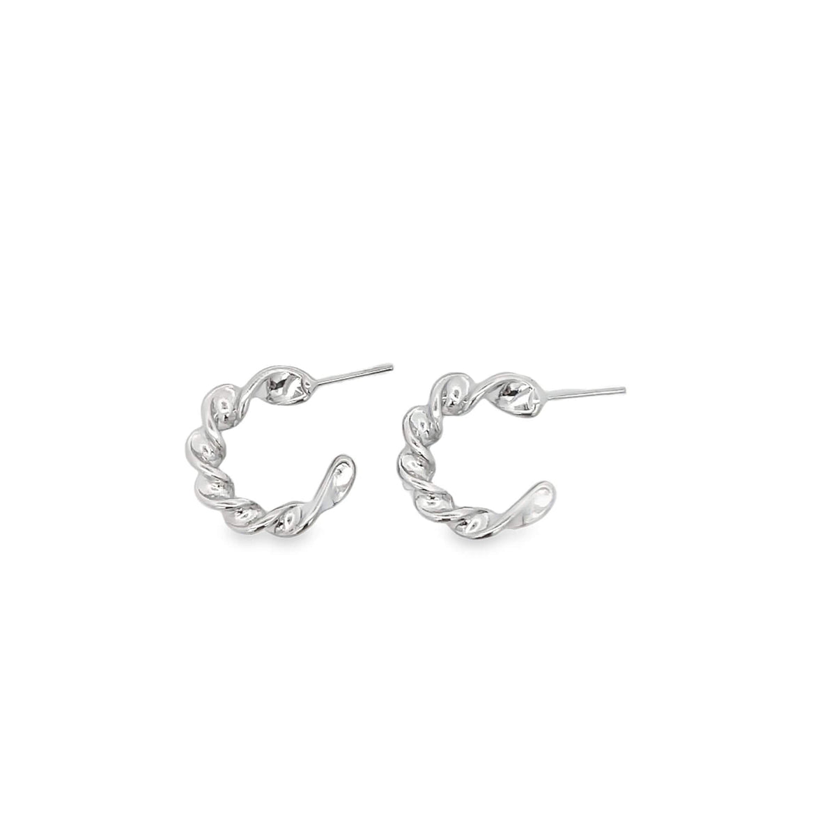 A pair of silver twisted rope hoop earrings rest against a clean white background.