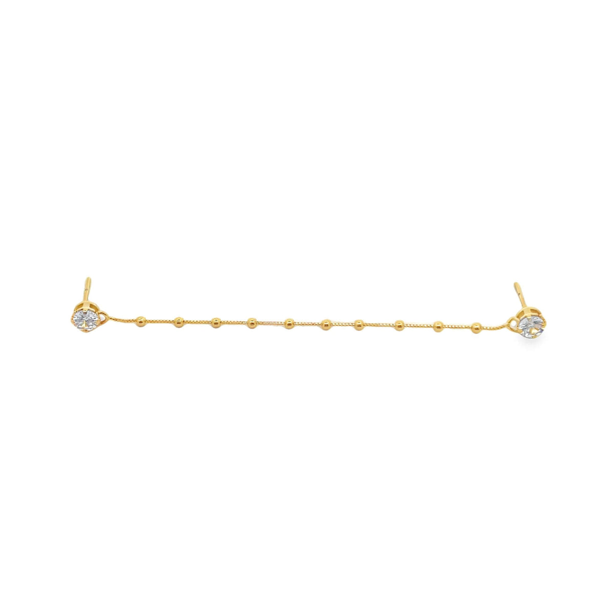 A gold double-piercing chain earring features sparkling cubic zirconia studs connected by a delicate beaded strand.