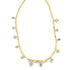 A delicate gold herringbone chain necklace drapes gracefully against a white background, featuring dangling charms in round, square, and teardrop shapes.