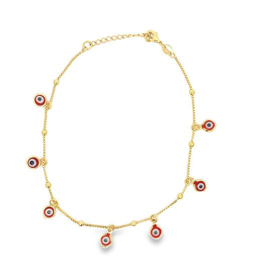 A delicate gold anklet features multiple dangling red, white, and black evil eye charms against a clean white background.
