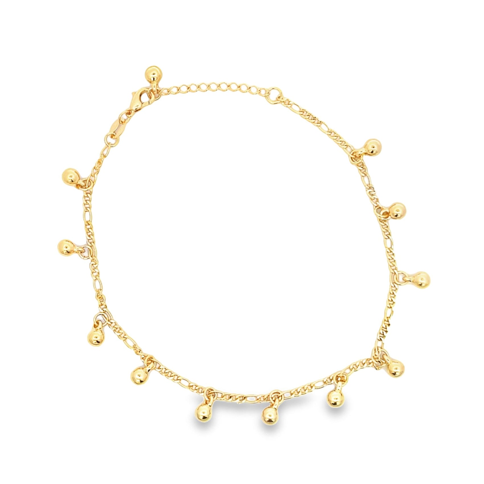 A delicate gold charm anklet features dangling spherical beads along a reflective chain against a plain white background.