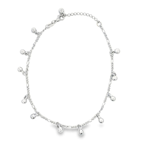 A delicate silver anklet adorned with dangling bead charms rests against a clean white background.