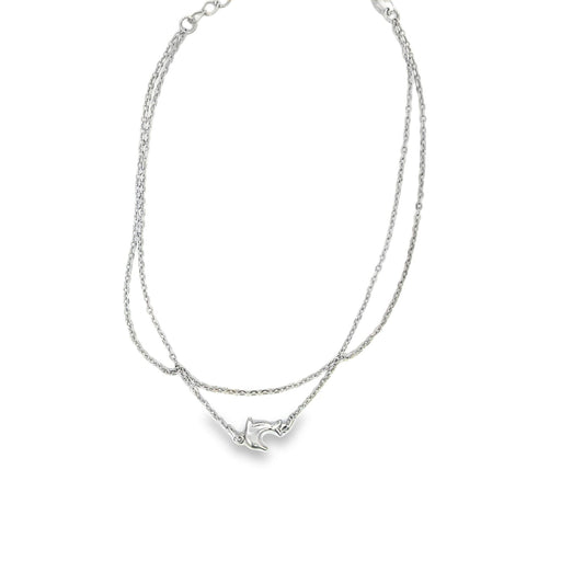 A double-strand silver anklet features a delicate dolphin charm centered on a white background.