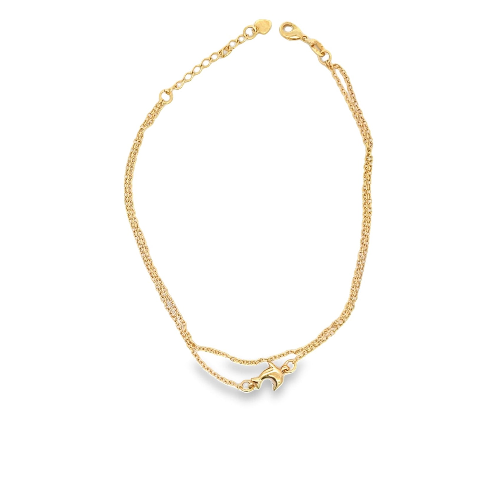 A delicate gold dolphin anklet features a double-layered chain resting on a white surface.