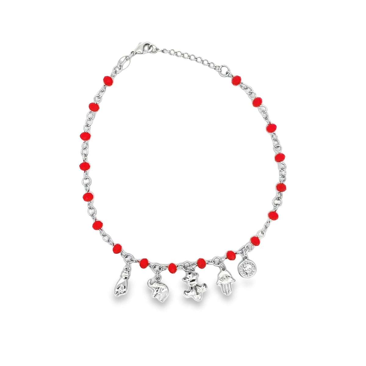 A silver charm anklet features bright red beads interspersed along the chain and hangs several dangling good luck charms against a plain white background.