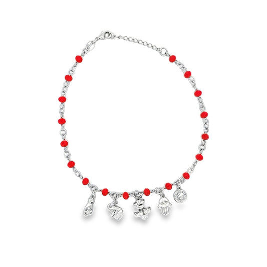 A delicate silver charm anklet features vibrant red beads and dangles a collection of symbolic charms against a clean white background.