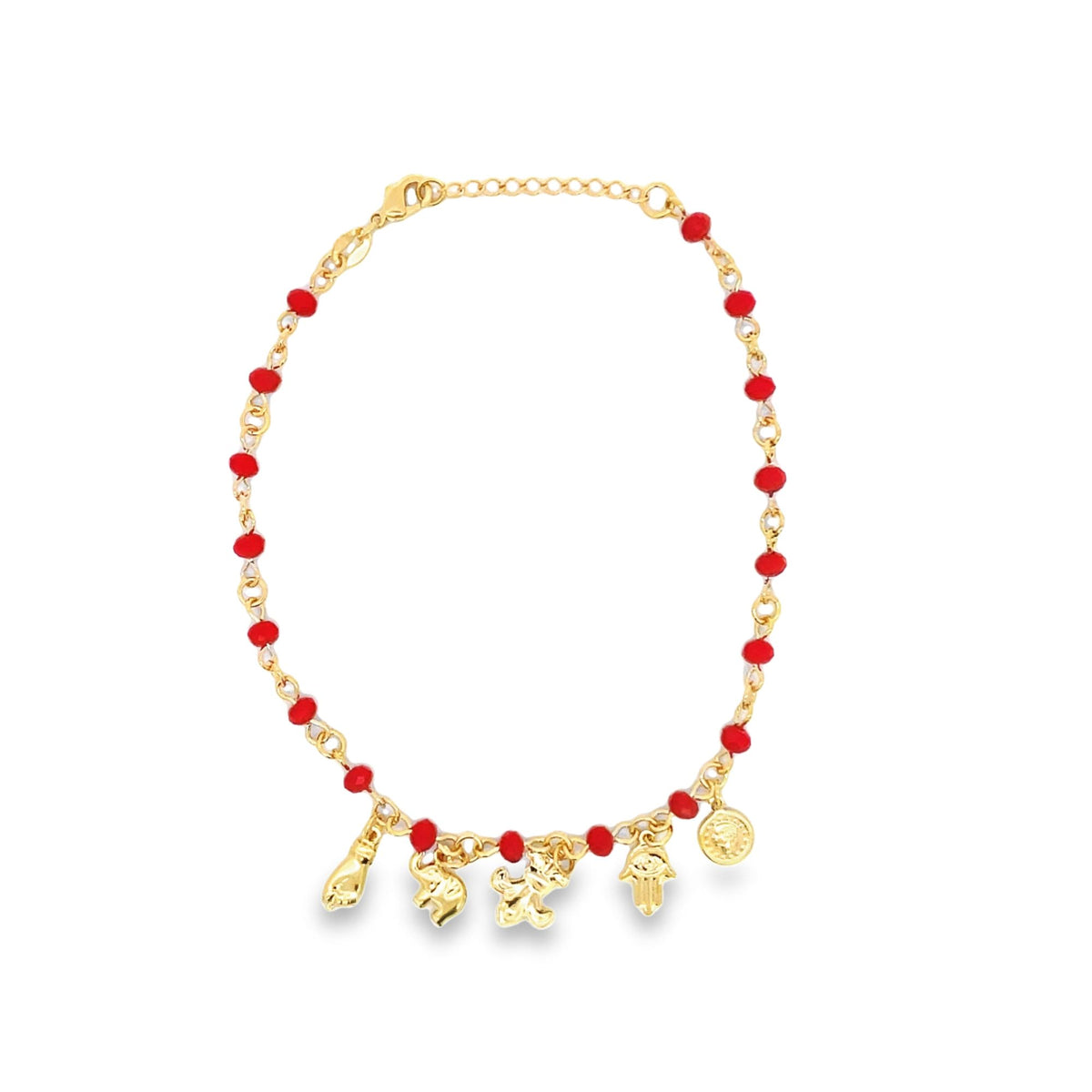 A gold charm bracelet features a delicate chain interspersed with vibrant red beads and dangling pendants against a plain white background.