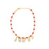 A delicate gold charm anklet features vibrant red beads and dangles playful gold charms against a clean white background.