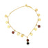 A delicate gold anklet features hanging coin charms and brown stone beads against a white background.
